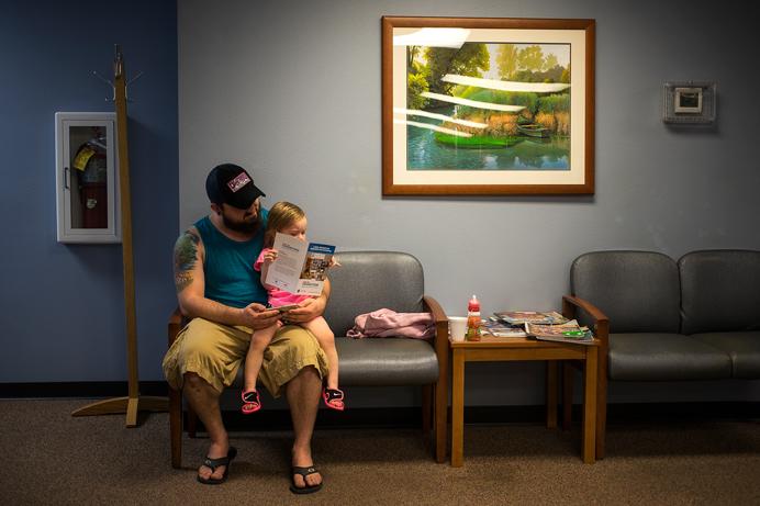 Kalona Resident and Army National Guard Infantry Veteran, Tristan Rempel, waits in the lobby for a Veterans Affairs appointment in Coralville with his daughter Emmalin on Monday, April 10, 2017. Tristan served in Afghanistan before returning to civilian life in 2015. (The Daily Iowan/James Year)