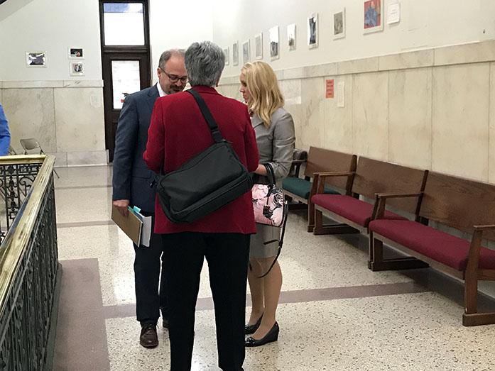 Thomas Newkirk, Donna Lopiano, and Jill Zwagerman speak outside the courtroom at the Polk County Courthouse on Thursday. Newkirk and Zwagerman are Meyers attorneys, Lopiano is an expert witness. (The Daily Iowan/Blake Dowson)