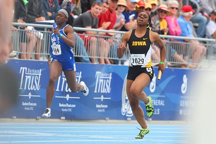 Iowa runner Brittany Brown crosses the finish line in the womens 4 x 100 meter relay at Drake Stadium on Saturday, April 26, 2014. Iowa won first place in this event. (The Daily Iowan/Joshua Housing)