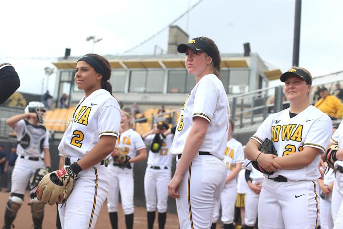 The Iowa team watch the intro on the big board before the game between Illinois and Iowa in Iowa City at Bob Pearl Field on Friday, March 24, 2017. The Fighting Illini were able to keep the Hawkeyes hitless and went on to win 8-0. (The Daily Iowan/ Alex Kroeze)