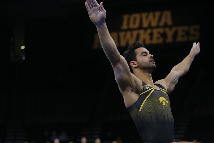 Iowa's Andrew Botto finishes his routine on floor during the Iowa-Nebraska match at Carver-Hawkeye Arena on Monday, March 20, 2017. The Hawkeyes defeated the Huskers, 408.300-400.000. (The Daily Iowan/Margaret Kispert)