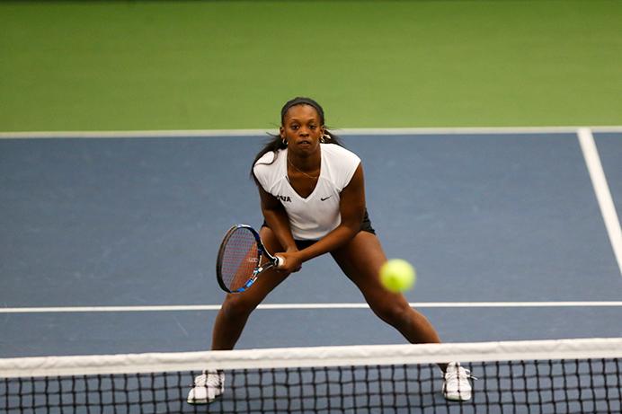 Adorabol Huckleby prepares to return a shot during the doubles tennis match against Indiana University's Caitlin Bernard and Natalie Whalen on Saturday March 11 at the Hawkeye Tennis and Recreation Complex. (Osama Khalid/The Daily Iowan)