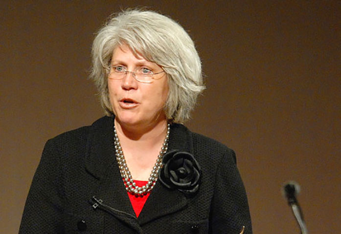 In this April 18, 2011 photo, Jane Meyer, senior associate athletic director at the University of Iowa, speaks in Normal, Ill. Meyer, the former no. 2 administrator for Iowa athletics will square off against the school in a trial beginning Monday, April 17, 2017, that centers on her claim that she suffered discrimination as a gay female who fought bias in college sports. The trial in a lawsuit brought by Meyer is expected to litigate whether Athletic Director Gary Bartas personnel moves were tough-but necessary judgment calls or tainted by discrimination. (Lori Ann Cook-Neisler/The Pantagraph via AP)