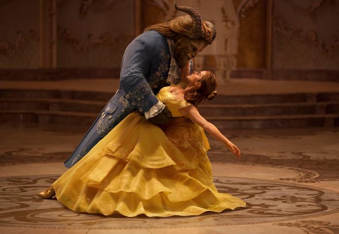 This image released by Disney shows Dan Stevens as The Beast, left, and Emma Watson as Belle in a live-action adaptation of the animated classic Beauty and the Beast. (Disney via AP)