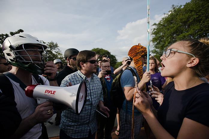 Kimberly Costen, Auburn freshman, right, yells at supports for Richard Spencer right to speak at Auburn University on Tuesday, April 18, 2017, in Auburn, Ala. The man who rented Foy Hall for Richard Spencer and was denied, filed a  law suit and was granted an injunction by a federal judge to allow Spencer to speak. (Albert Cesare/The Montgomery Advertiser via AP)
