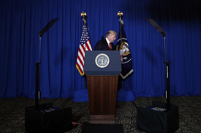 In this April 6, 2017, photo, President Donald Trump walks from the podium after speaking at Mar-a-Lago in Palm Beach, Fla., Thursday, April 6, 2017, after the U.S. fired a barrage of cruise missiles into Syria. Trump’s White House, one perpetually plagued by infighting among aides jockeying for the president’s ear, has been sharply divided by a new rivalry, one pitting his powerful son-in-law with unfettered access to the president against the sharp-elbowed ideologue who fueled Trump’s populist campaign rhetoric. (AP Photo/Alex Brandon)