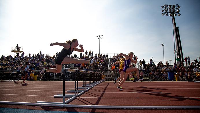 Athletes+clear+the+hurdles+during+the+100+meter+hurdles+during+the+Musco+Twilight+event+at+Francis+X.+Cretzmeyer+Track+on+Saturday%2C+April+23%2C+2016.+The+Musco+Twilight+brings+in+track+and+field+athletes+from+all+over+Iowa+to+compete+for+Iowa+City+fans.+%28The+Daily+Iowan%2FAnthony+Vazquez%29