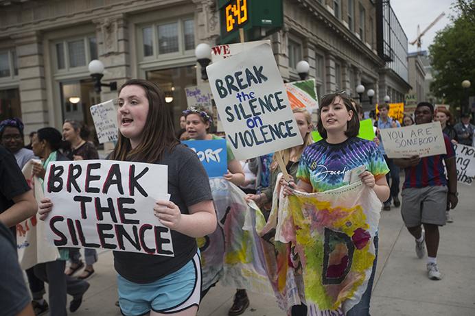 Community members participate in a march for Take Back the Night on Tuesday, April 25, 2017. Take Back the Night was a sexual assault awareness event. (The Daily Iowan/Joseph Cress)