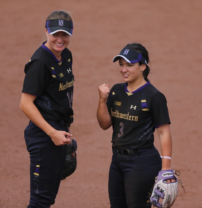 Northwestern infielders Brooke Marquez and Alcy Bush signal that the baserunner was out during the game between Iowa/Northwestern at Pearl Field on Sunday, May 7, 2017. On Iowas senior day they fell to the Wildcats 5-2. (The Daily Iowan/ Alex Kroeze)