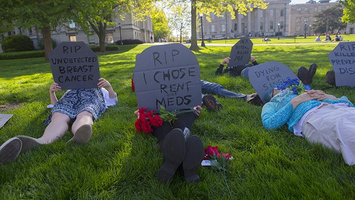 Protestors die during a protest against the American Health Care Act on the Pentacrest on Sunday, May 7, 2017. The protest featured several speakers and a die-in. (The Daily Iowan/Lily Smith)
