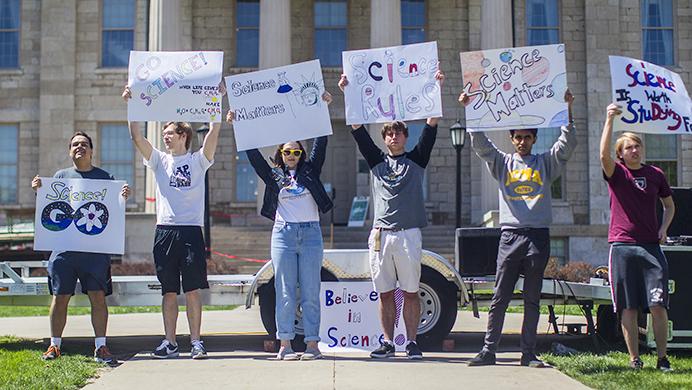 Student protestors hold signs during the Iowa March for Science at the Pentacrest Lawn on Saturday, April 22. The groups goal is to persuade legislators to vote based on scientific-backed research as opposed to partisan policy. (The Daily Iowan/Ben Smith)