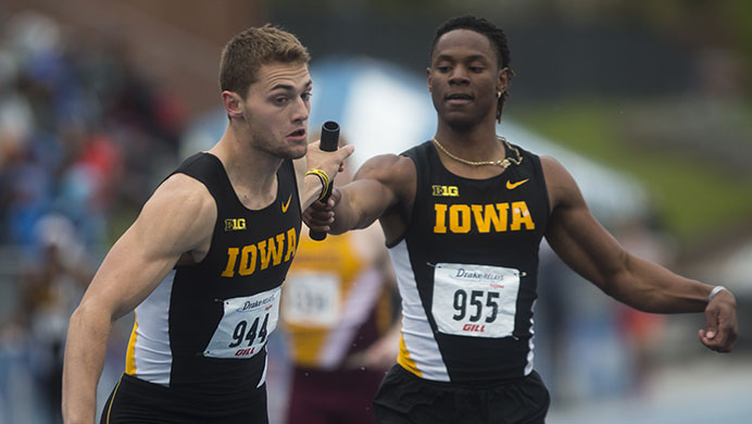 Iowa's Emmanuel Ogwo hands off the baton to Collin Hofacker during the 4x400 at Drake Stadium during the Drake Relays on Saturday, April 29, 2017. Iowa won, with a time of 3:07.35. (The Daily Iowan/Joseph Cress)