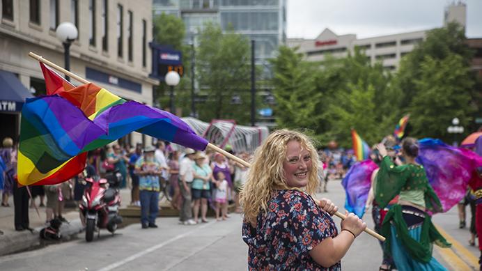 Lexi+Ridout%2C+a+parade+participant%2C+marches+on+Dubuque+St.+with+flag+in+hand+during+the+IC+Pride+Parade+on+Saturday%2C+June+17.+The+parade+is+a+part+of+LBGT+Pride+Month%2C+established+in+1969+to+commemorate+the+Stonewall+riots.+%28Ben+Smith%2FThe+Daily+Iowan%29