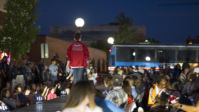 A model walks in the Fashion 500 fashion show during the Iowa City Downtown District Block Party on Saturday June 25, 2017. The Block Party, hosted by the ICDD was the first use of Iowa City's changed rules allowing open containers for select events downtown (Nick Rohlman/The Daily Iowan)