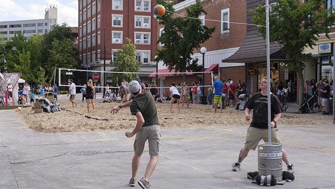 Partygoers play tetherball on Dubuque Street during the Iowa City Downtown District Block Party on Saturday June 25, 2017. The Block Party, hosted by the ICDD was the first use of Iowa City's changed rules allowing open containers for select events downtown (Nick Rohlman/The Daily Iowan)