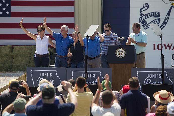 Iowa Governor Kim Reynolds, Vice President Mike Pence, and Senator Joni Ernst wave to supporters during the third annual Roast and Ride event in Boone, Iowa, on Saturday, June 3, 2017. Guests included Vice President Mike Pence; Sen. Tim Scott, R-S.C.; Sen. Chuck Grassley, R-Iowa; Iowa Gov. Kim Reynolds; and Rep. Steve King, R-Iowa. (The Daily Iowan/Nick Rohlman)