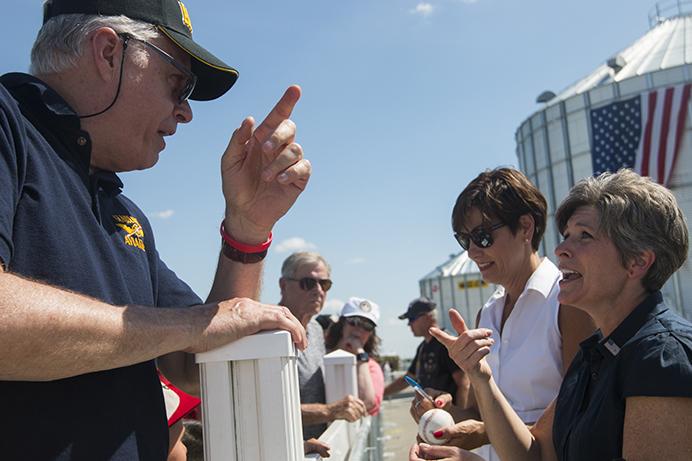 Sen. Joni Ernst, R-Iowa, (right) talks with a constituent while Iowa Gov. Kim Reynolds signs a baseball during the third annual Roast and Ride event in Boone, Iowa, on Saturday, June 3, 2017. Guests included Vice President Mike Pence; Sen. Tim Scott, R-S.C.; Sen. Chuck Grassley, R-Iowa; Iowa Gov. Kim Reynolds; and Rep. Steve King, R-Iowa. (The Daily Iowan/Joseph Cress)