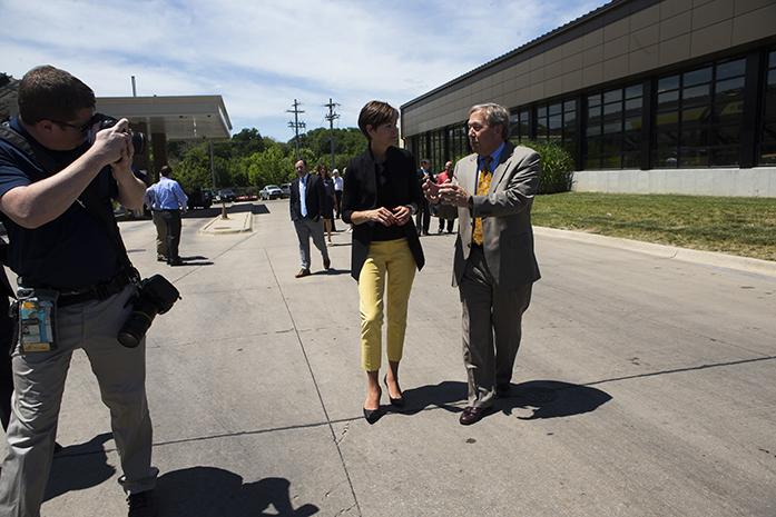 FILE - Iowa Gov. Kim Reynolds talks with University of Iowa President J. Bruce Harreld after a visit on the University of Iowa campus to learn about diversifying biomass fuel sources on at the Cambus Maintenance Facility on Wednesday, June, 7, 2017. Reynolds and Lt. Gov. Adam Gregg met with Harreld and other university experts on their visit while discussing the universitys biomass portfolio. (The Daily Iowan/Joseph Cress)