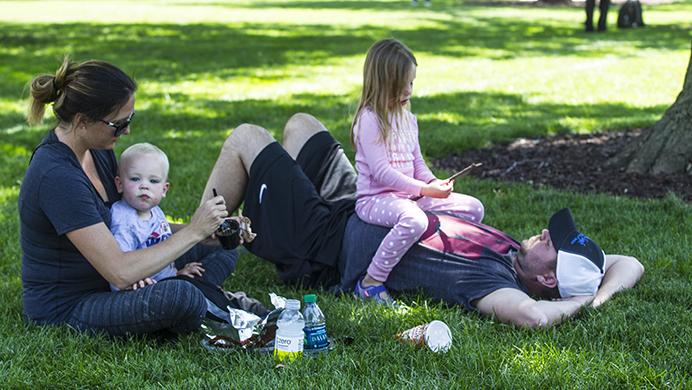 The Schlee Family is relaxing in the Pentacrest on Tuesday, June 27. The family visited Iowa City for the first time as they drove to Omaha, Nebraska from Michigan. (Hieu Nguyen/The Daily Iowan)