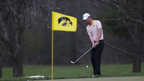 Iowas Raymond Knoll swings onto the green during the Hawkeye Invitational at Finkbine Golf Course on Saturday, April 15, 2017. Iowa currently sits in third after one and a half rounds in the tournament, play was delayed late Saturday afternoon due to inclement weather. (Joseph Cress/The Daily Iowan)