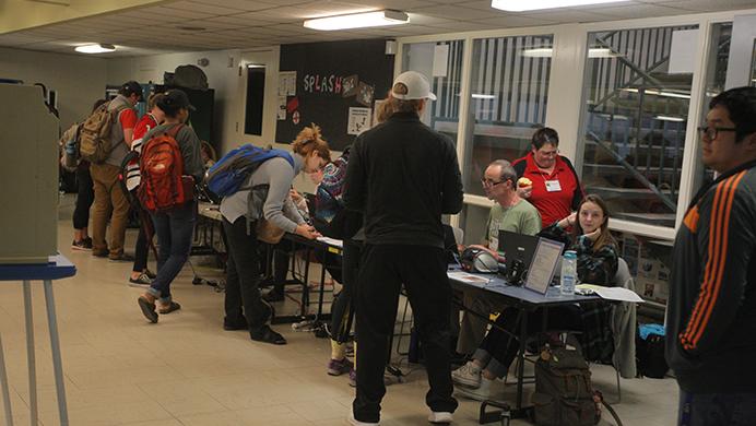 Voters register to vote in the Robert A. Lee Recreation Center in Iowa City on Tuesday, Nov. 8, 2016. Iowa voters could register at their polling places. (The Daily Iowan/Joseph Cress)