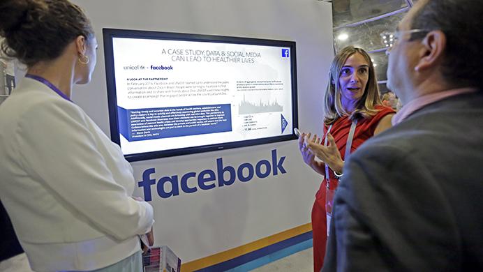 Laura+Juanes+Micas%2C+of+Facebook%2C+center%2C+talks+to+visitors+about+the+how+teaming+data+and+social+media+can+help+people+live+healthier+lives%2C+at+the+Facebook+booth%2C+at+eMerge+Americas+technology+conference%2C+at+the+Miami+Beach+Convention+Center%2C+Tuesday%2C+June+13%2C+2017%2C+in+Miami+Beach%2C+Fla.+eMerge+Americas+is+a+platform+for+the+advancement+of+technology%2C+a+forum+for+idea+exchange%2C+and+a+launch+pad+for+innovation+connecting+Latin+America%2C+North+America%2C+and+Europe.+%28AP+Photo%2FAlan+Diaz%29