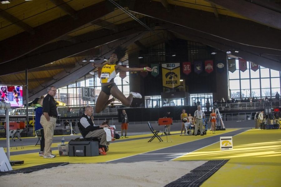 FILE - In this file photo, Iowa junior Jahisha Thomas leaps through the air into the sand pit during the Border Battle indoor track meet in the UI Recreation Building with Iowa, Missouri and Illinois competing on Saturday, Jan. 7, 2017. Thomas competed on July 1-2 at the United Kingdom World team trials in the triple jump and the long jump. 
 (Joseph Cress/The Daily Iowan, File)