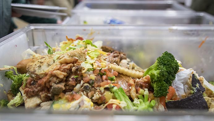 Compostable food waste is tracked in plastic bins at Hillcrest Dining Hall on Wednesday, March 8, 2017. The food is being weighed as part of a food waste audit to measure students' trash.