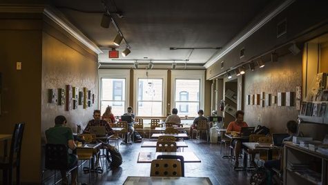 Iowa City residents enjoy coffee and the quiet atmosphere at Prairie Lights on Tuesday, July 4, 2017. 