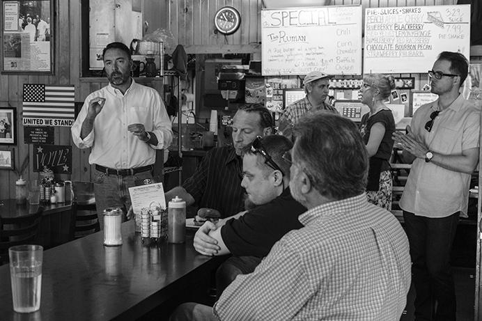 Iowa 2nd Congressional District candidate Chris Peters speaks with customers at the Hamburg Inn on Sunday July 31, 2017. Peters is running against Rep. Dave Loebsack in 2018. (Nick Rohlman/The Daily Iowan)