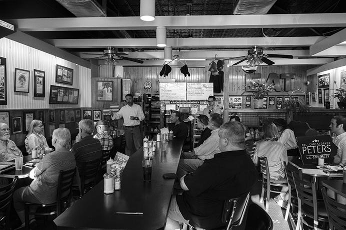 Iowa 2nd Congressional District candidate Chris Peters speaks with customers at the Hamburg Inn on Sunday July 31, 2017. Peters is running against Rep. Dave Loebsack in 2018. (Nick Rohlman/The Daily Iowan)