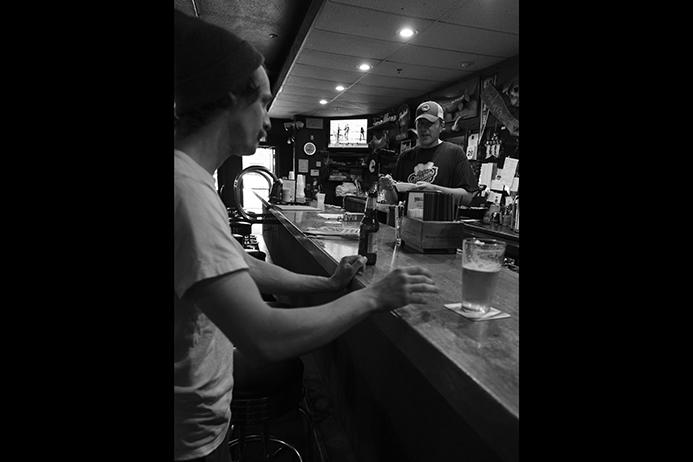 Bartender Ben Mummey talks to patrons at the Deadwood Tavern in Iowa City on Thursday June 29, 2017. On July 1,  Ben Mummey bought the Deadwood from longtime owner Jim Bell. (Nick Rohlman/The Daily Iowan)