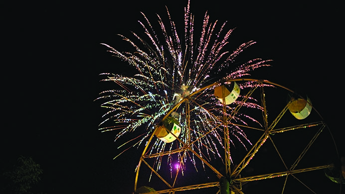 Fireworks+go+off+over+a+ferris+wheel+inside+Coralvilles+S.T.+Morrison+Park.+The+night+ended+with+a+fireworks+show+after+a+day+of+activities+including+a+parade+and+a+carnival.+%28The+Daily+Iowan%2FSergio+Flores%29