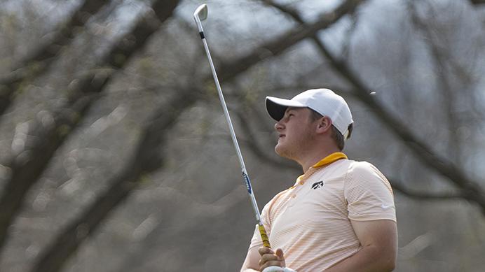 Iowas Alex Schaake watches a ball fly during the Hawkeye Invitational at Finkbine Golf Course on Saturday, April 15, 2017. Iowa currently sits in third after one and a half rounds in the tournament, play was delayed late Saturday afternoon due to inclement weather. (The Daily Iowan/Joseph Cress)