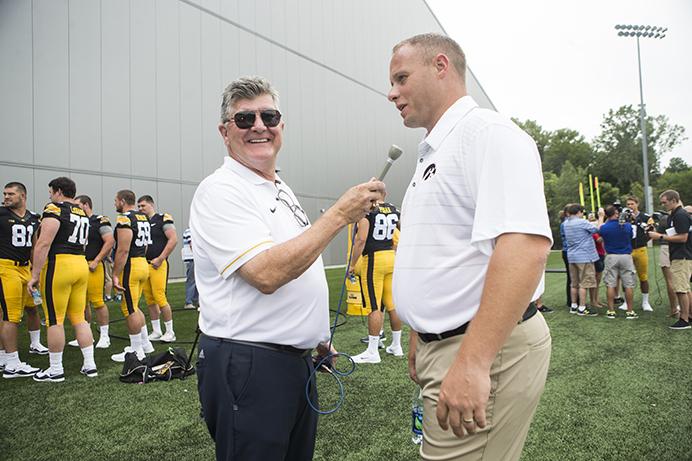 Veteran voice of the Hawkeyes Gary Dolphin speaks with Iowa linebackers coach Seth Wallace during Iowa football media day on Saturday, Aug. 5, 2017. The Hawkeyes will play open up non-conference play against Wyoming at 11 a.m. (CT) on Saturday, Sept. 2. 