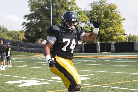 Iowa offensive linemen Tristian Wirfs warms up during a summer camp practice at the outdoor practice facility on Monday, Aug. 7, 2017. 