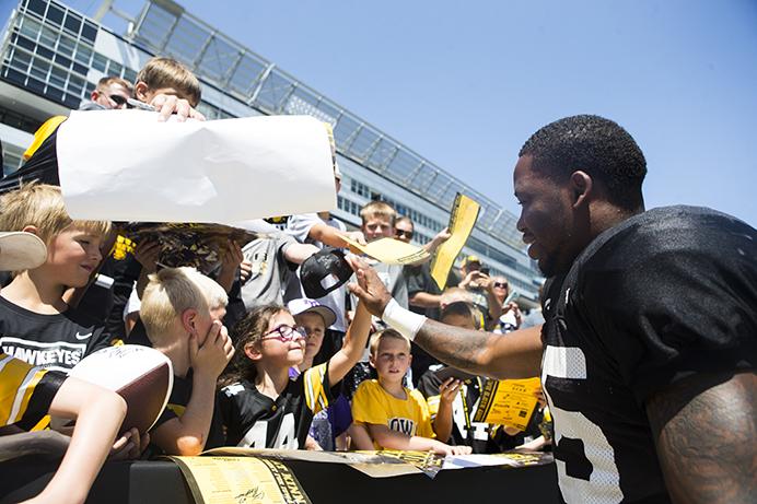 Iowa+running+back+Akrum+Wadley+high-fives+a+fan+after+signing+a+poster+for+them+during+the+annual+Kids+Day+at+Kinnick+event+in+Kinnick+Stadium+on+Saturday%2C+Aug.+12%2C+2017.++The+Hawkeyes+will+play+open+up+non-conference+play+against+Wyoming+at+11+A.M.++on+Saturday%2C+Sept.+2+%28Joseph+Cress%2FThe+Daily+Iowan%29