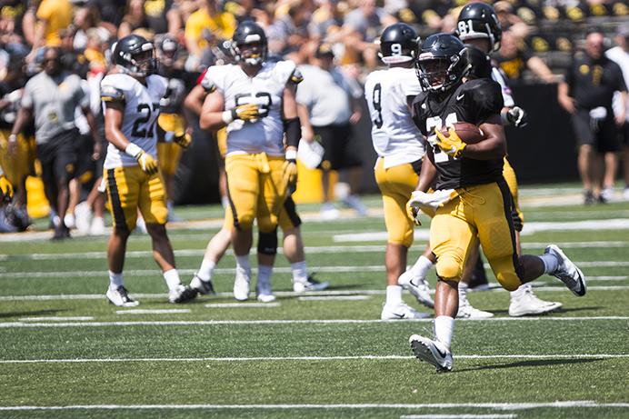 Iowa+running+back+Ivory+Kelly-Martin+runs+to+the+end+zone+for+a+touchdown+during+the+annual+Kids+Day+at+Kinnick+event+in+Kinnick+Stadium+on+Aug.+12.++The+Hawkeyes+will+open+up+nonconference+play+against+Wyoming+at+11+on+Sept.+2.