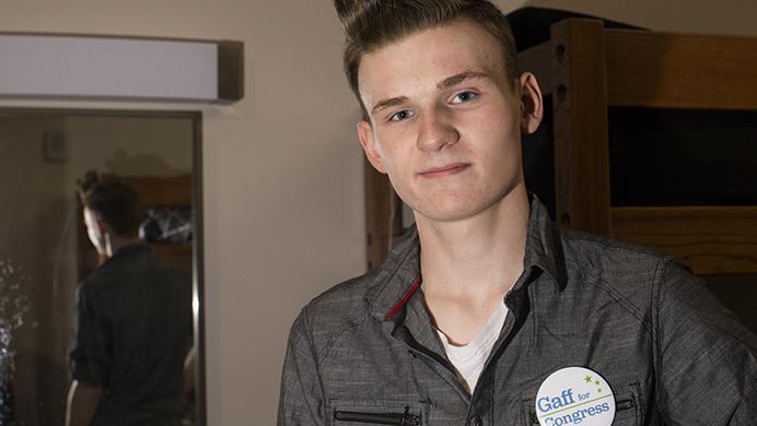 UI freshman Henry Gaff shows off his campaign button in his Catlett room on Monday, August 28, 2017. Gaff, of Cedar Falls, is the Green Party candidate running for Iowa’s 1st Congressional District seat held by Rep. Rod Blum, R-Iowa. The U.S. Constitution requires members of the House be 25 or older. (Joseph Cress/The Daily Iowan)