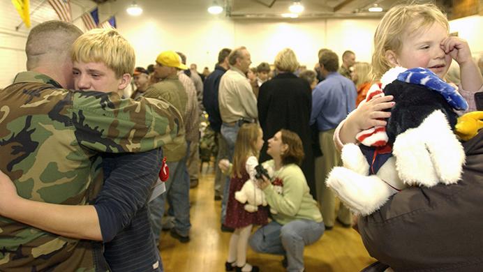 In this February 25, 2004 file photo, soldiers say goodbye to their families at the National Guard Armory. The 1-168th Infantry Battalion was deployed to active duty in the Middle East. (Nick Loomis/The Daily Iowan)