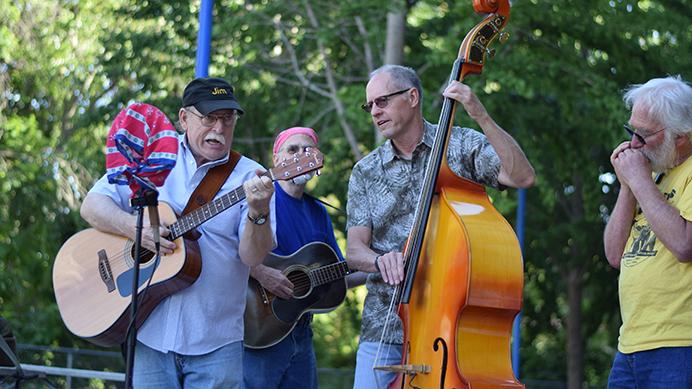 The Bluegrass group Sweet Cacophony picks and plucks away at the Iowa City Farmers Market, Wednesday, August 23. The next market is Saturday the 26. (Paxton Corey/The Daily Iowan)