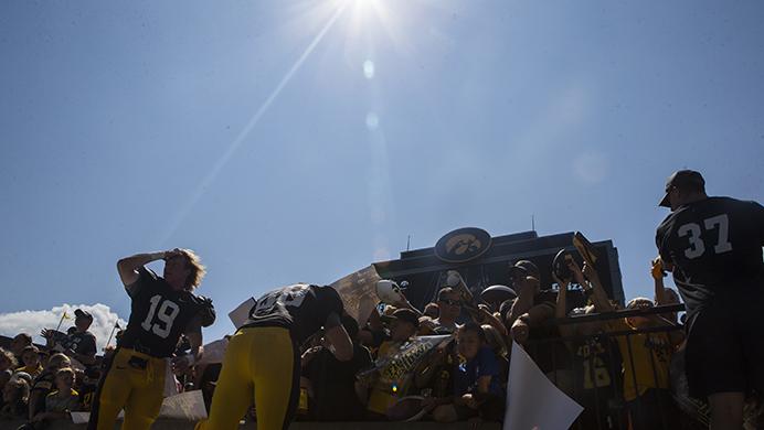 Iowa's Max Cooper, Jacob Coons and Brandon Snyder sign autographs for fans during the annual Kids Day at Kinnick event in Kinnick Stadium on Saturday, Aug. 12, 2017.  The Hawkeyes will play open up non-conference play against Wyoming at 11 a.m. on Saturday, Sept. 2 (Joseph Cress/The Daily Iowan)