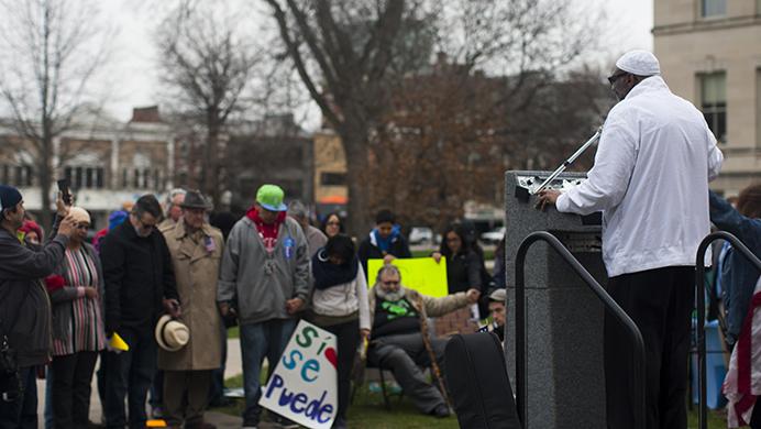 A speaker begins with a prayer at the LULAC worker's rally in front of the Old Capitol on March 30, 2017. The organization LULAC has about 16 different councils and 500 members in the state of Iowa. (The Daily Iowan/Kenny Sim)