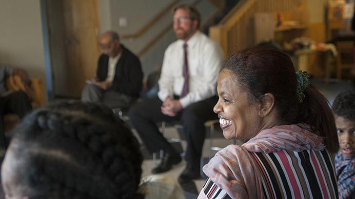 FILE - Mazahir Salih, the president of the Center for Worker Justice, laughs at a shared experience told during a listening post at the Pheasant Ridge Neighborhood Center on April 1, 2016.  (The Daily Iowan/file)