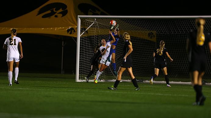 Iowa goal keeper Claire Graves reaches out for the ball over Michigan midfielder Abby Kastroll during the Iowa v. Michigan match at the Iowa Soccer Complex on Friday, September 16, 2016. The Wolverines defeated the Hawkeyes in a close 1-0 match. (The Daily Iowan/ Alex Kroeze)