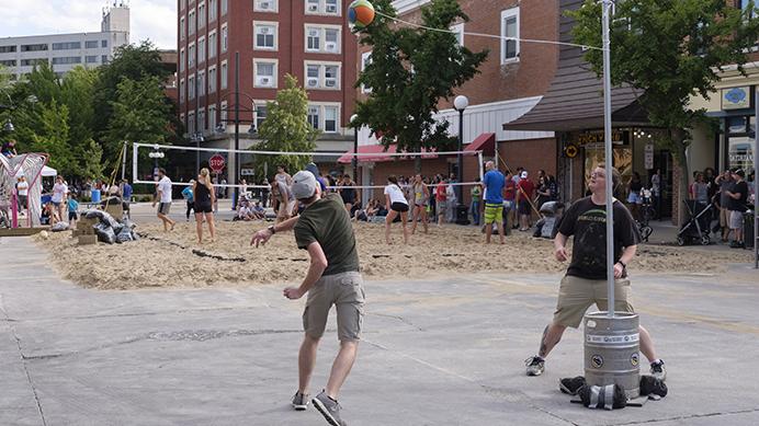 Partygoers play tetherball on Dubuque Street during the Iowa City Downtown District Block Party on Saturday June 25, 2017. The Block Party, hosted by the ICDD was the first use of Iowa Citys changed rules allowing open containers for select events downtown (Nick Rohlman/The Daily Iowan)