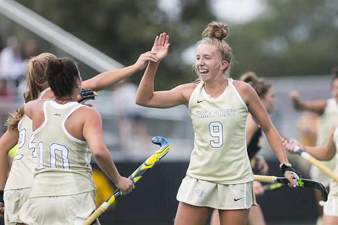 Wake Forest midfielder Emily Adamson (9) high-fives teammates after scoring a goal during a field hockey game during the Big Ten/ACC Challenge at Grant Field in Iowa City on Saturday, Aug. 26, 2017. The Hawkeyes fell to Wake Forest, 3-2. (Joseph Cress/The Daily Iowan)