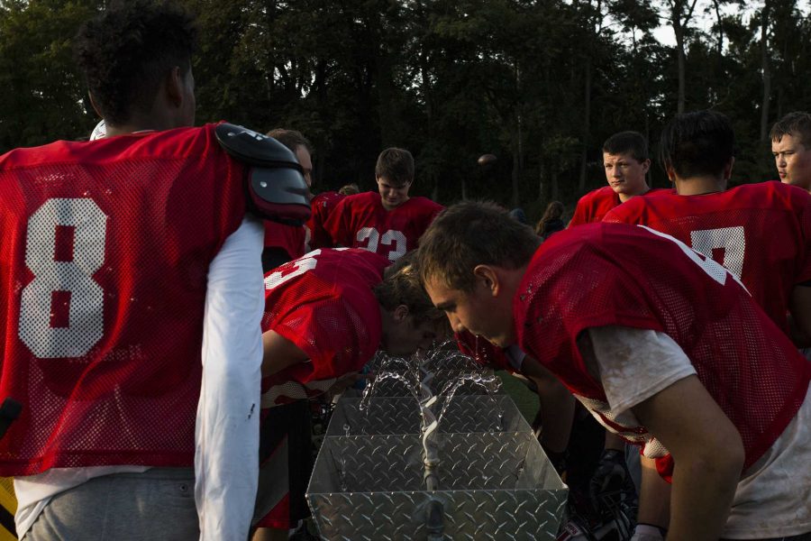 Players hydrate during a 4A  varsity football practice on Wednesday, Sept. 6, 2017. The Little Hawks are headed to Ames on Sept. 8 to take on the Little Cyclones to compete for the Little Cy-Hawk trophy. City High will take on Ames High for the 5th year in a row, the night before the Hawkeyes take on Iowa State. (Joseph Cress/The Daily Iowan)