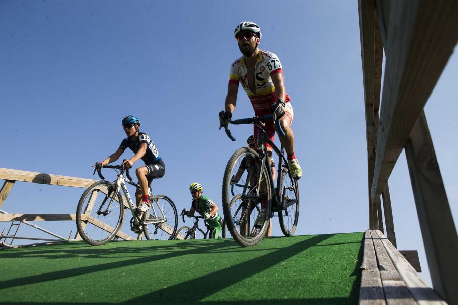 Cyclocross riders roll down a flyover during the first day of Jingle Cross at the Johnson County fairgrounds on Friday, Sept. 15, 2017. The three day cyclocross event will host events Friday night, masters ones on Saturday under the lights, and the UCI Telenet Cyclocross World Cup to close out the weekend on Sept. 17. Joseph Cress/The Daily Iowan)