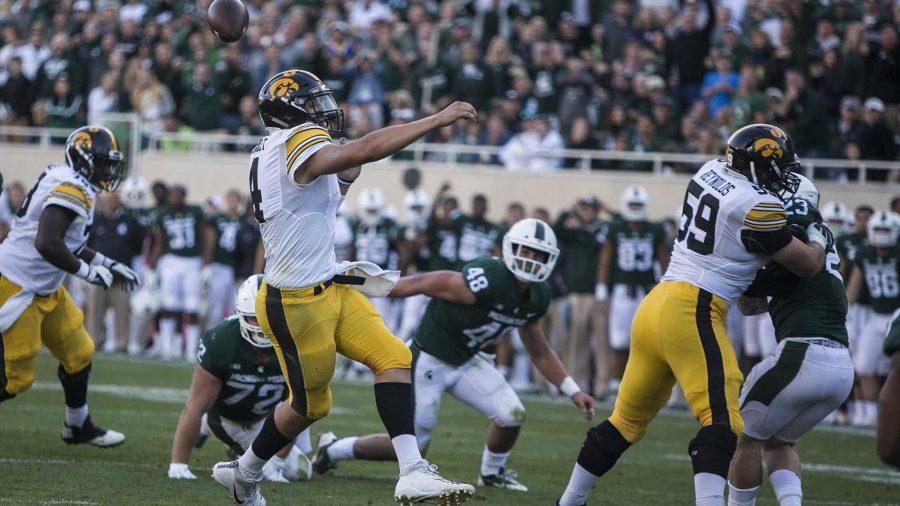 Iowa quarterback Nathan Stanley fumbles the ball during the game between Iowa and Michigan State at Spartan Stadium on Sept. 30. The Hawkeyes fell to the Spartans with a final score of 10-17. (Ben Smith/The Daily Iowan)